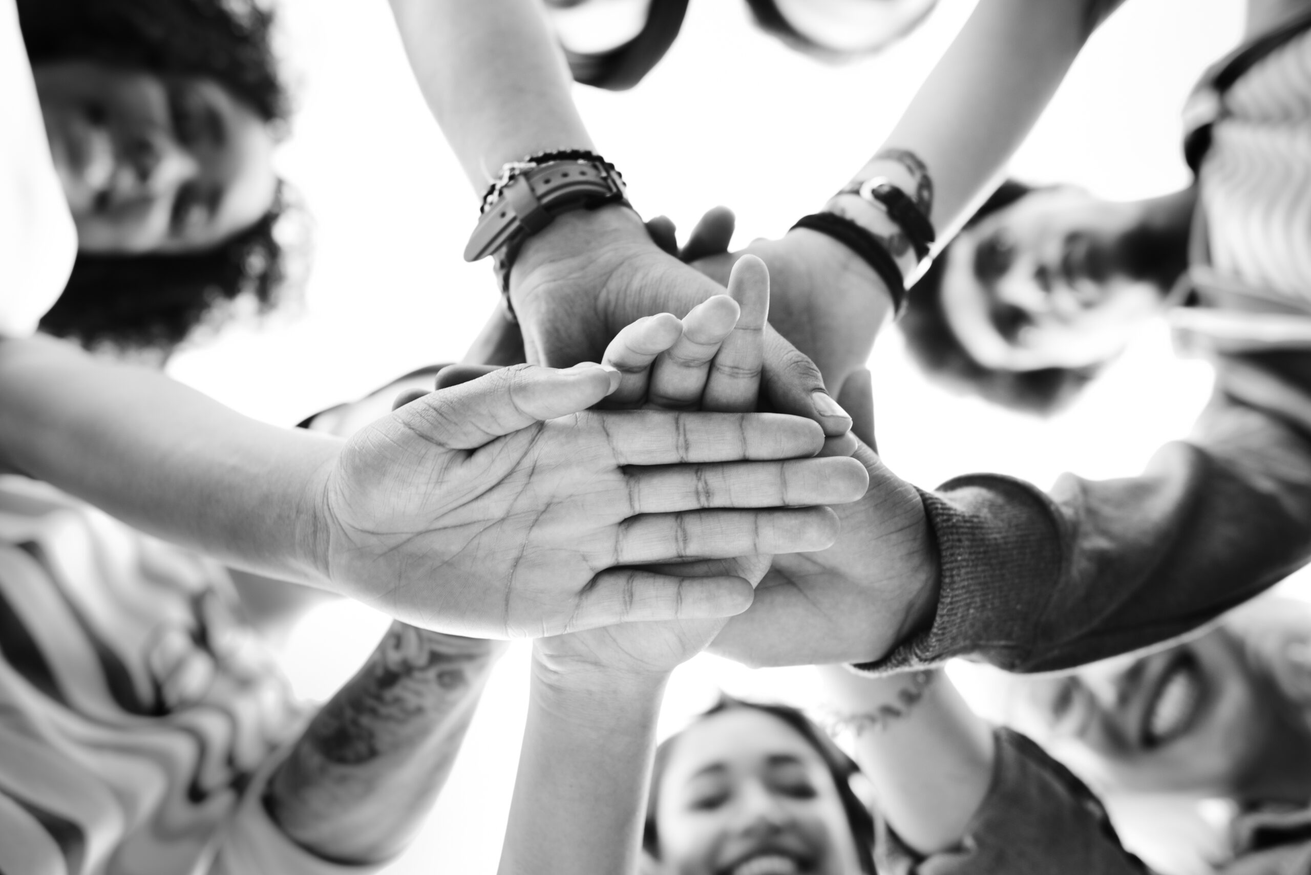 Team stacking hands showing team culture.