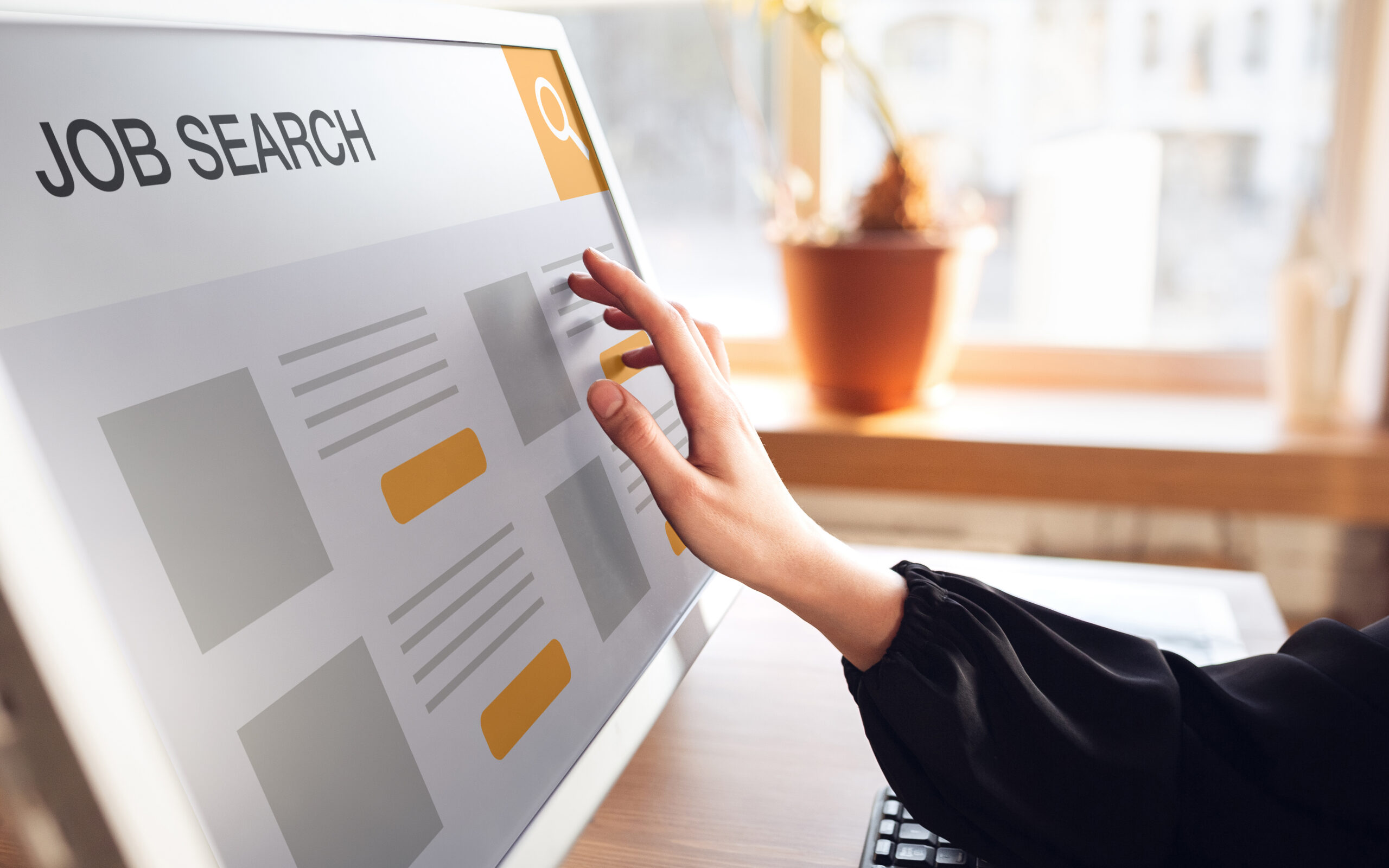 A hand touching the screen while job hunting for a position.