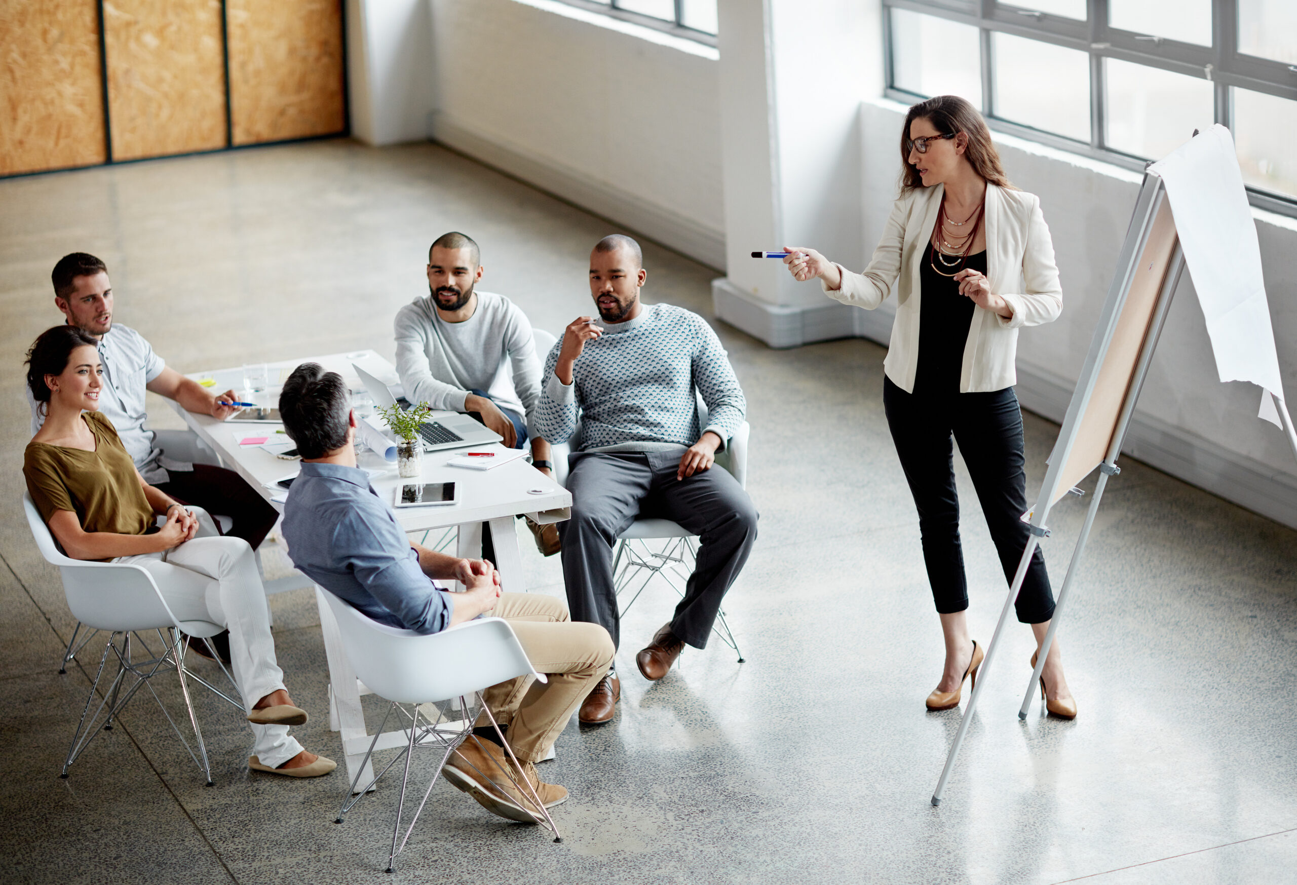 A sales team having a meeting about customer churn.